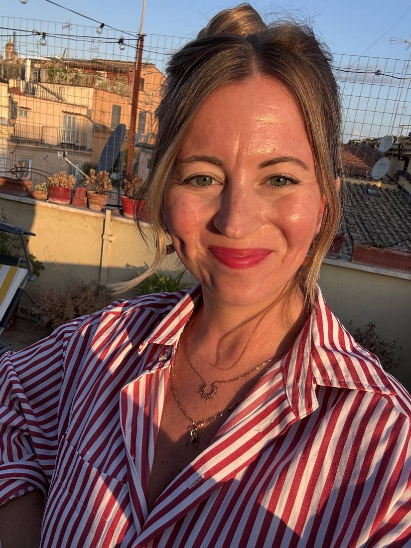 Dr. Jenn Overstreet on a Rome rooftop in golden light